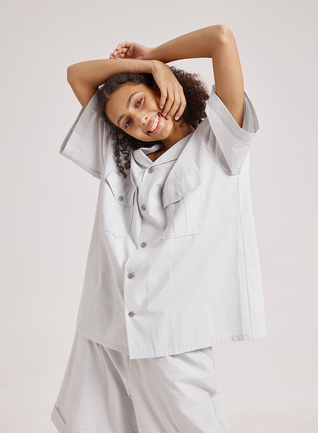 model wearing loose shirt with pockets